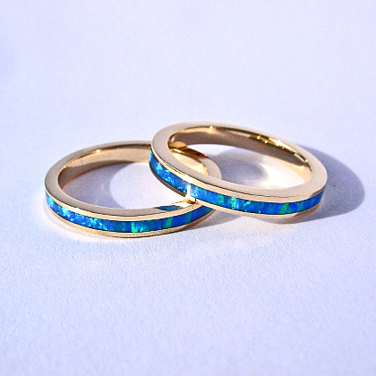 Yellow gold and cultured opal bands
