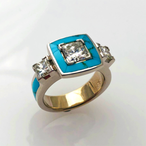 18 karat white gold ring with a 1 carat  princess cut Diamond center stone with a Turquoise halo surrounding it.  On each side of the halo are two princess cut diamonds .  On each side of the Diamonds are two more turquoise inlay. Southwest Originals 505-363-7150