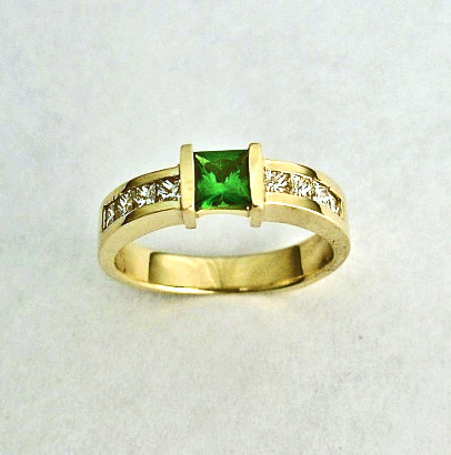 Gold, Diamond, and Tsavorite (Green Garnet) Ring SWE0055 14 karat gold ring with 8 Princess Cut Diamonds Channel set and a Princess Cut Tsavorite Center Stone.